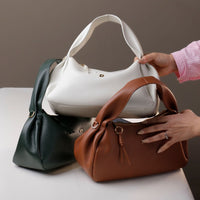 Group shot of Danilo’s Aurora Bags – mixed colors displayed with gold chain accessories