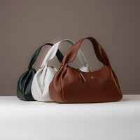 Trio of Aurora Soft Bags in brown, ivory, and navy – premium sculpted leather bags by Danilo’s