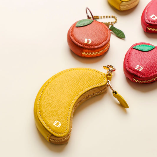 Banana, strawberry, and lemon leather keychains by Danilo’s – handcrafted fruit-shaped accessories with gold hardware