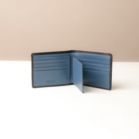 Blue wallet with open design on a beige background