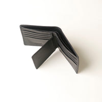 Opened Black leather wallet on a white background