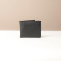 Closed Black leather wallet on a beige background