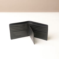 Open Black leather wallet on a white background