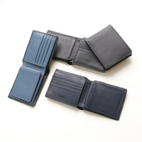 Four leather wallets in different colors on a white background