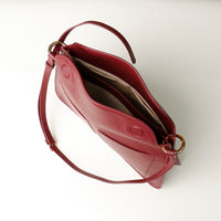 Interior of red Penelope Sr. handbag – microsuede lining and magnetic fold-over closure