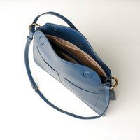 Top view of blue Penelope Sr. handbag – interior with magnetic clasp and three-compartment accordion design
