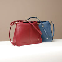 Red and blue Penelope Sr. leather bags – structured square handbags with top handles by Danilo’s