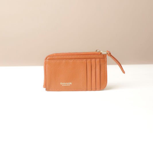 Light Brown leather card case wallet with a zipper on a beige background