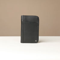 Front view of a black Danilos Pebble leather Document Portfolio Alfaro on a beige background