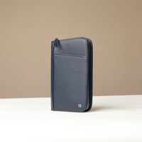 Side view of a blue Danilos Pebble leather Document Portfolio Alfaro on a beige background