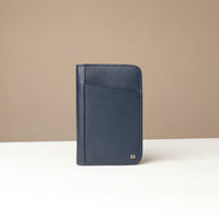 Front view of a blue Danilos Pebble leather Document Portfolio Alfaro on a beige background