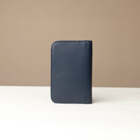 Back view of a blue Danilos Pebble leather Document Portfolio Alfaro on a beige background
