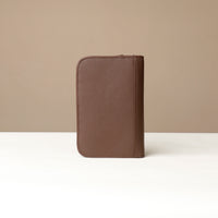Back view of a Brown Danilos Pebble leather Document Portfolio Alfaro on a beige background