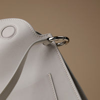 Interior view of white Penelope Sr. bag – microsuede lining with organizational compartments