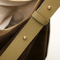 Close-up of olive suede shoulder strap – gold hardware and topstitch detail on Mia Minimale bag by Danilo’