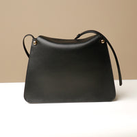 Black Penelope Sr. leather shoulder bag – sophisticated structured purse with front pockets and magnetic closure