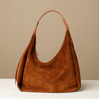 Front view of tan Mia Minimale – minimalist suede hobo shoulder bag with smooth curve