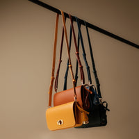 collection of four crossbody bags bith gold clasp