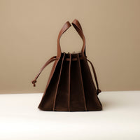 Backside view of Suede Papillon Sr. in brown – soft pleated bucket silhouette with drawstring fastening