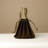 Back angle of green olive Suede Papillon Sr. – elegant sculptural profile with wide-set handles