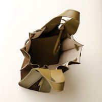 Three-quarter angle of green olive suede Papillon bag – structured pleated profile with knotted straps