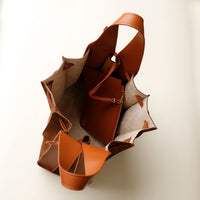 Overhead view of tan Papillon Sr. – open suede bucket bag showing interior lining and leather detail