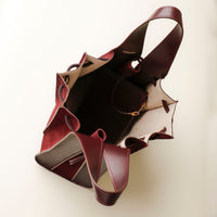 top view of burgundy Suede Papillon Sr. – pleated suede bucket handbag with leather trim