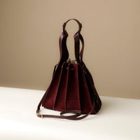 back view of burgundy Suede Papillon Sr. – pleated suede bucket handbag with leather trim