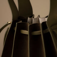 Top-handle view of olive green Suede Papillon Sr. – luxury suede handbag with soft volume