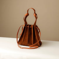 Close-up of tan Suede Papillon Sr. top handles – structured suede and leather craftsmanship