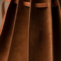 Close-up of tan Suede Papillon Sr. top handles – structured suede and leather craftsmanship