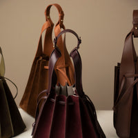 close up of Group of Suede Papillon bags in black, olive, and burgundy – sculptural suede bucket bags by Danilo’s