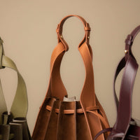 Group of Suede Papillon bags in brown, olive, and burgundy – sculptural suede bucket bags by Danilo’s