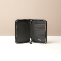 Front view of a open black passport case lovable in pebble leather with a Danilos logo, 8 card slots and 2 main slots