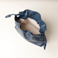 Top-down view of navy Sassy Satchel – interior lining and cinched closure with knotted leather ties