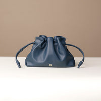Navy Sassy Satchel – ruched leather drawstring pouch with knotted details and gold D emblem