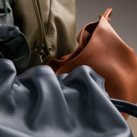 ruched Stack of Danilo’s Sassy Satchel bags in terracotta, navy, olive, and forest green – ruched leather drawstring purses handcrafted in premium nappa leather