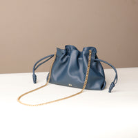 Top-down view of navy Sassy Satchel – interior lining and cinched closure with knotted leather ties and gold chain