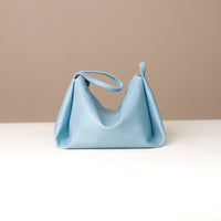 Close-up of Danilo’s logo on blue leather Silueta – premium craftsmanship detail