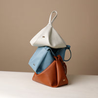 Silueta Bag trio – handcrafted luxury leather handbags in brown, ivory, and blue