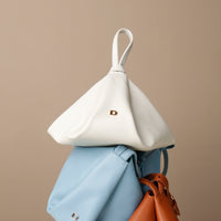 Lifestyle shot of white Silueta Bag styled with accessories – artisanal fold-over design