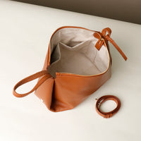 Top-down interior view of brown Silueta – lining with gold hardware