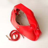 Interior view of red Aurora Soft Bag – zippered lining and gold hardware detail