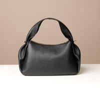 Rear view of black leather Aurora Bag – adjustable strap and sculptural draping