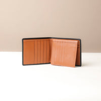 Brown leather wallet on a beige background