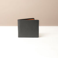 Black leather wallet on a beige background