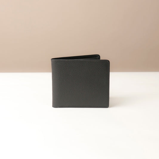 Black leather wallet on a beige background