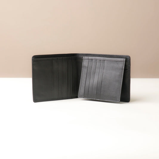Black leather wallet open on a beige background