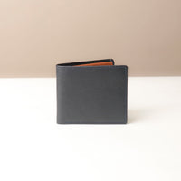 Blue leather wallet on a white surface with a beige background