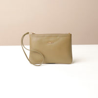 Beige wristlet pouch with a strap on a beige background
